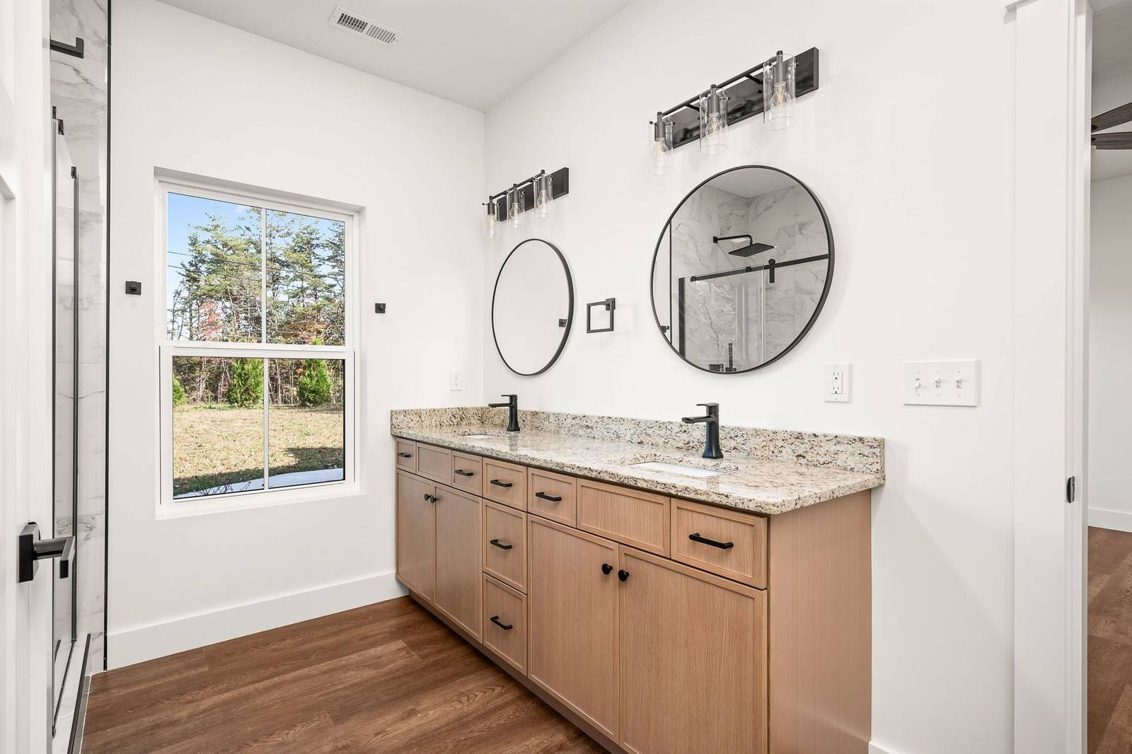 Double-vanity bathroom with granite top and black fixtures