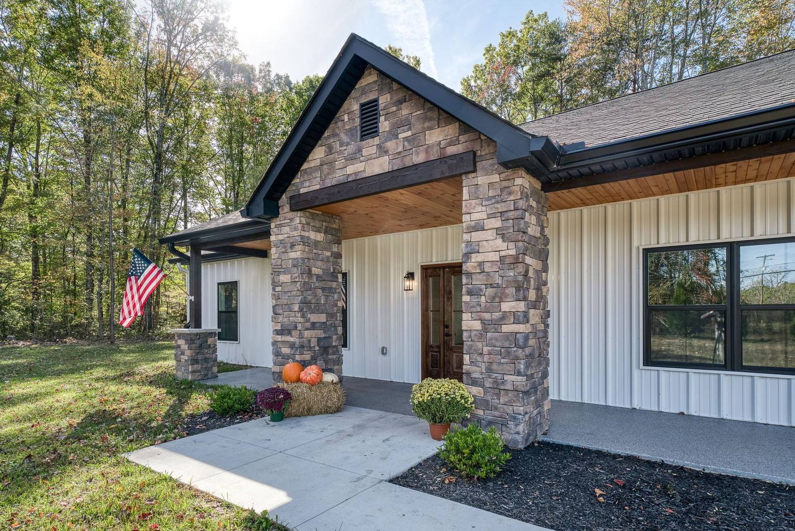 Covered stone-column entry on a TruBuild custom home