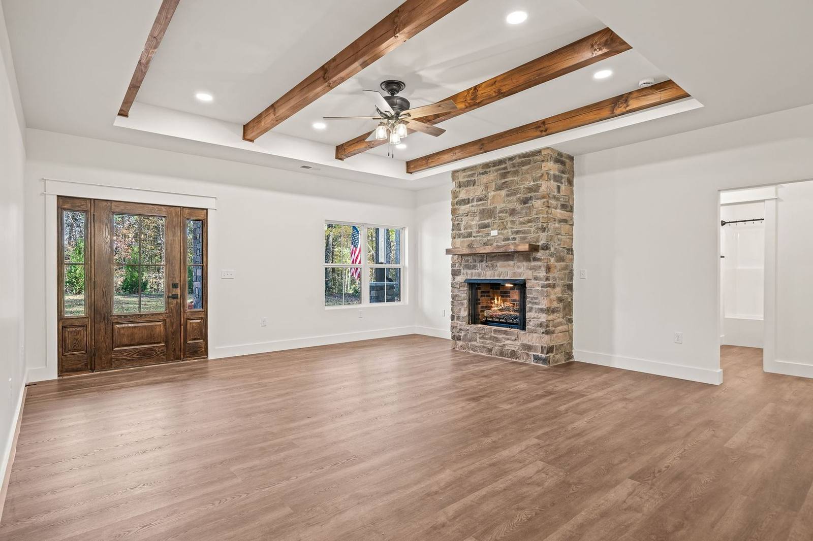 Entry view into the great room with vaulted beam ceiling