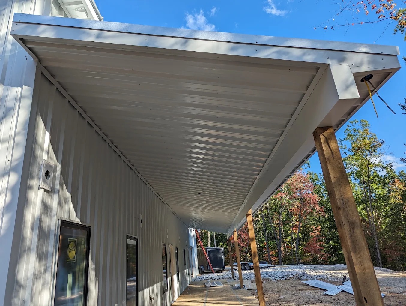 Covered porch addition under construction on an existing TruBuild-built structure